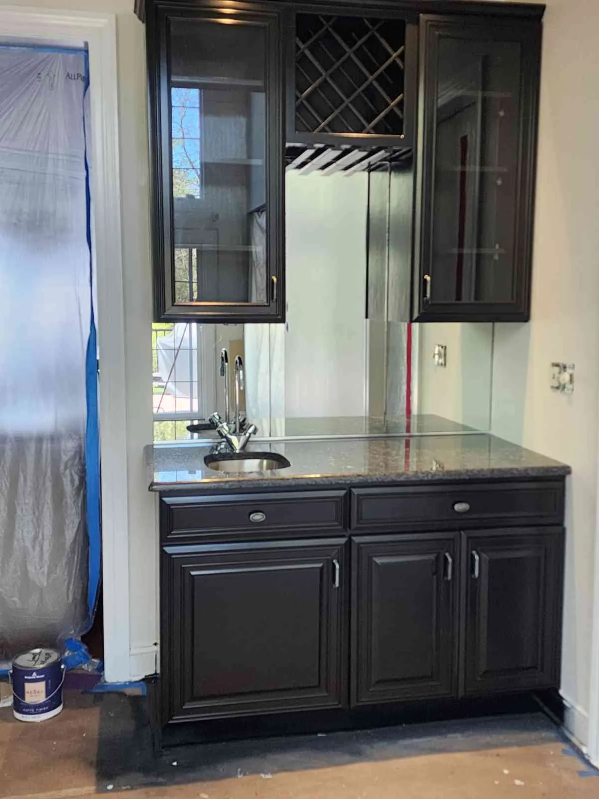 After: bar cabinets refinished in black with glass doors