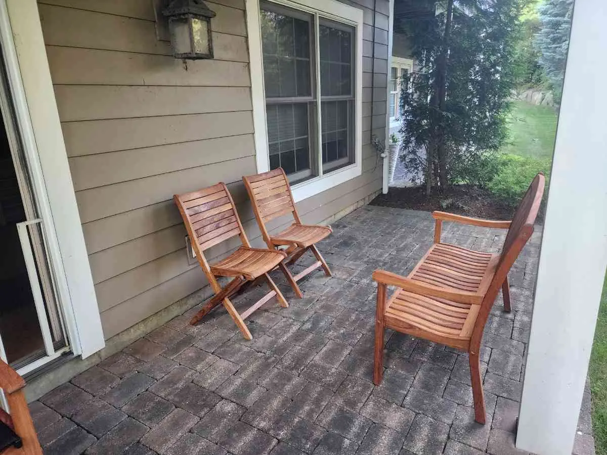 Covered porch with painted siding and paver patio
