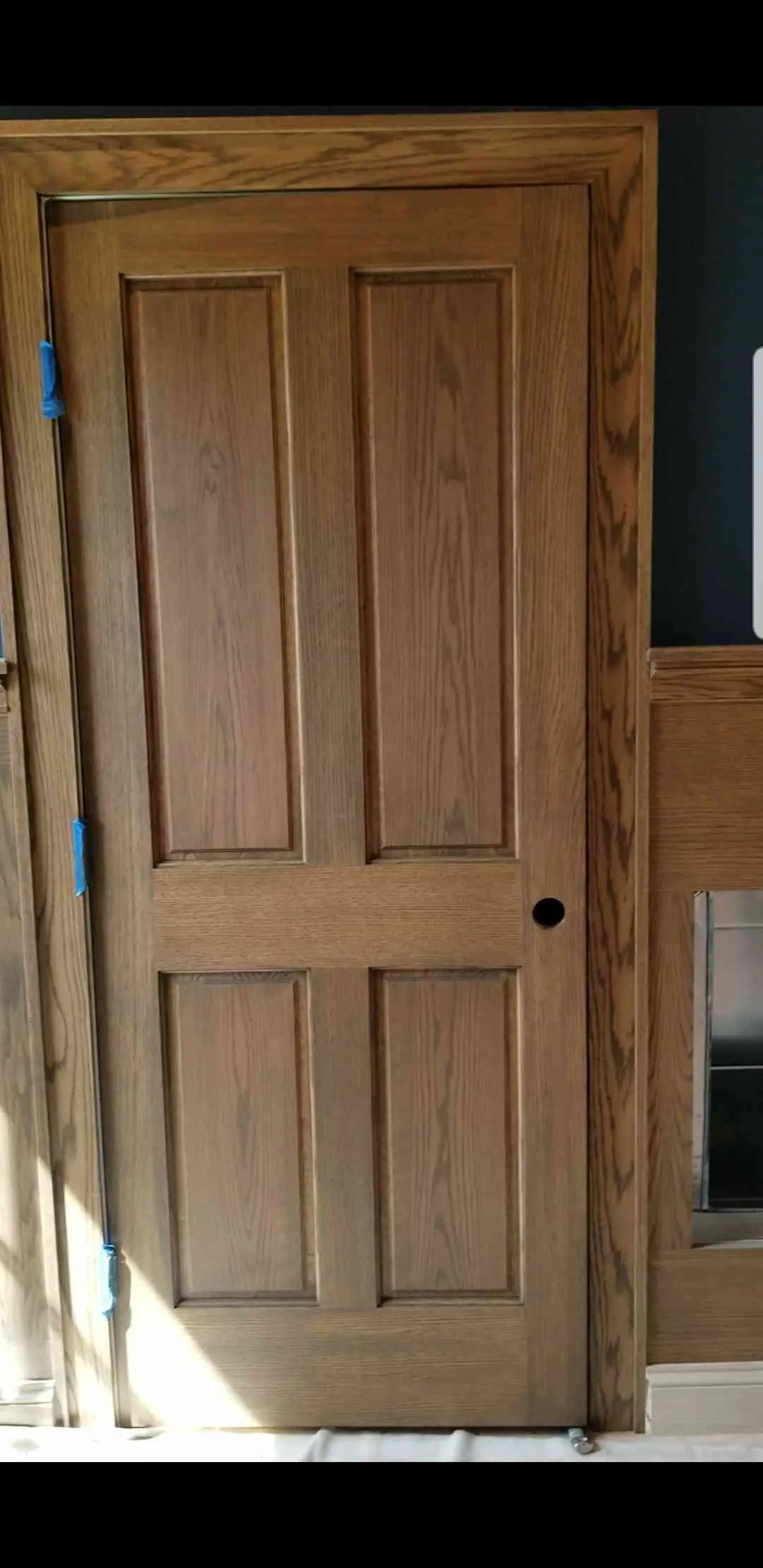 Newly installed stained wood panel door